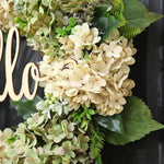 Green hydrangea crown with "Hello" sign
